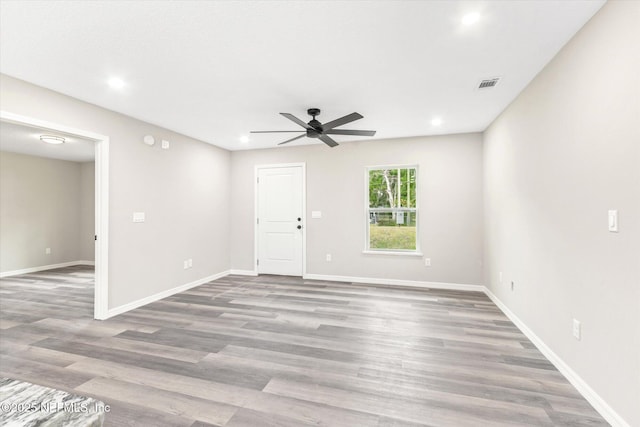 spare room featuring ceiling fan and hardwood / wood-style flooring