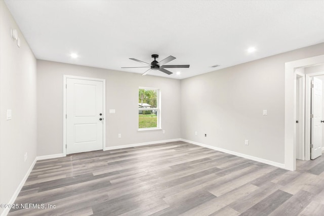 spare room featuring ceiling fan and light hardwood / wood-style flooring