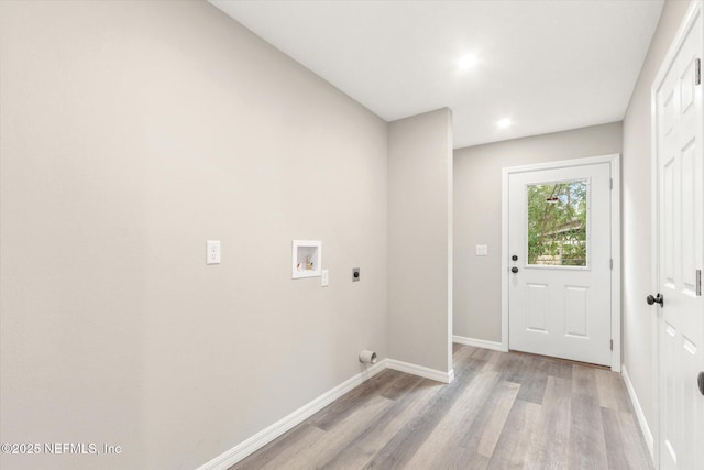 clothes washing area featuring washer hookup, electric dryer hookup, and light hardwood / wood-style floors