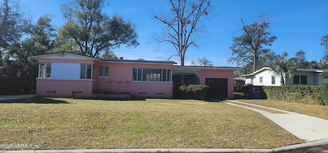 view of front of house with a garage and a front lawn