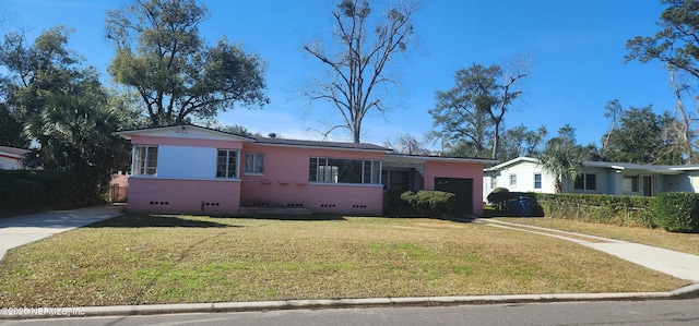 single story home with a garage and a front yard