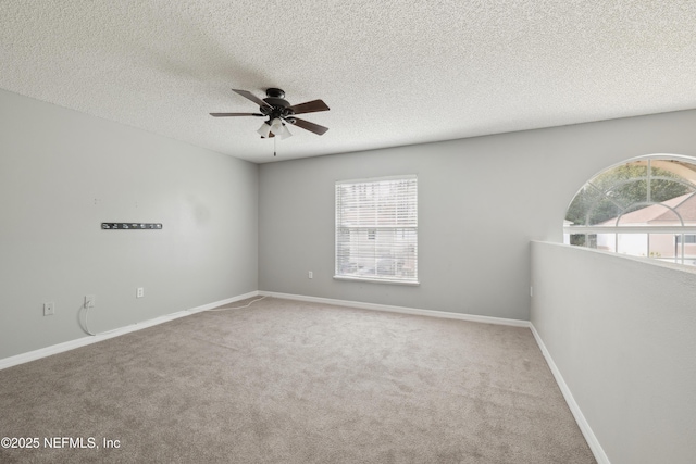 carpeted empty room featuring a textured ceiling and ceiling fan