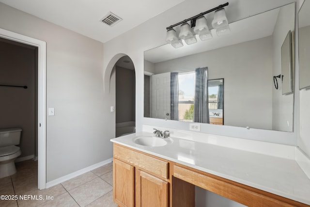 bathroom with vanity, toilet, and tile patterned flooring