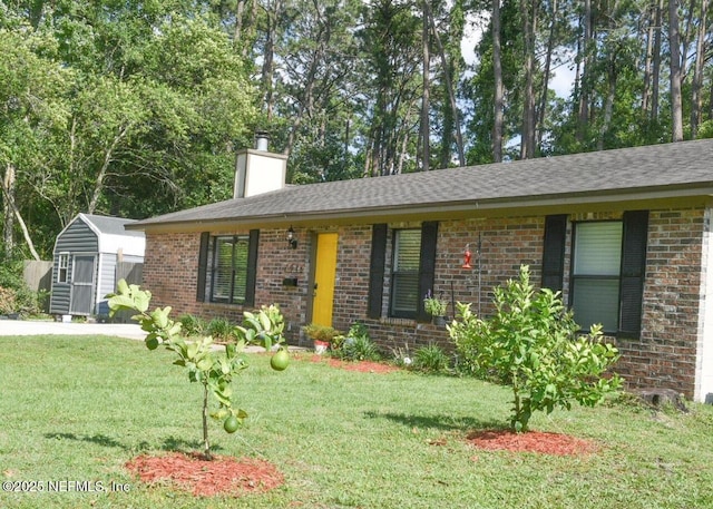 ranch-style home with a shed and a front yard