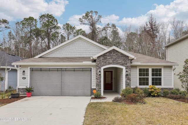 view of front of property with a garage and a front lawn