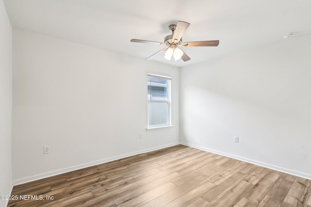 unfurnished room with ceiling fan and hardwood / wood-style floors