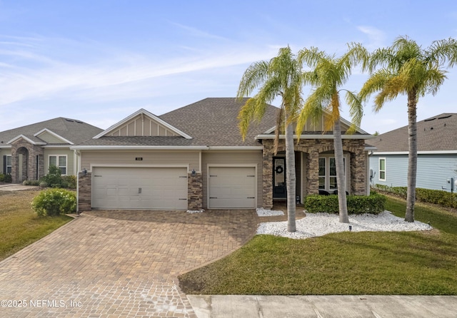 view of front of home featuring a garage and a front yard