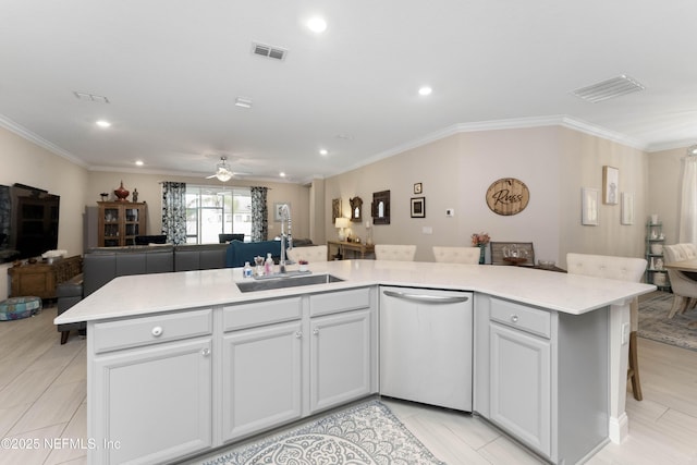 kitchen featuring ceiling fan, sink, stainless steel dishwasher, and an island with sink