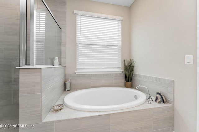 bathroom featuring separate shower and tub