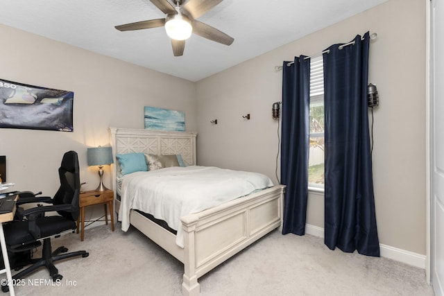 bedroom featuring ceiling fan and light carpet