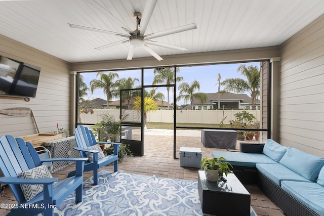 sunroom / solarium featuring ceiling fan and plenty of natural light