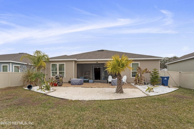 back of house featuring a patio area, a yard, and a sunroom