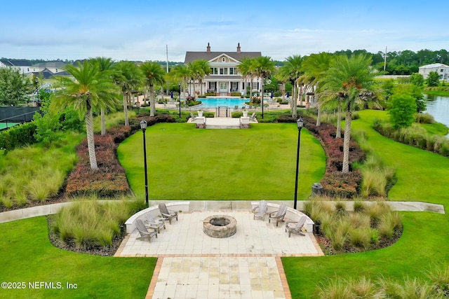 view of property's community featuring a patio area, a pool, and a fire pit