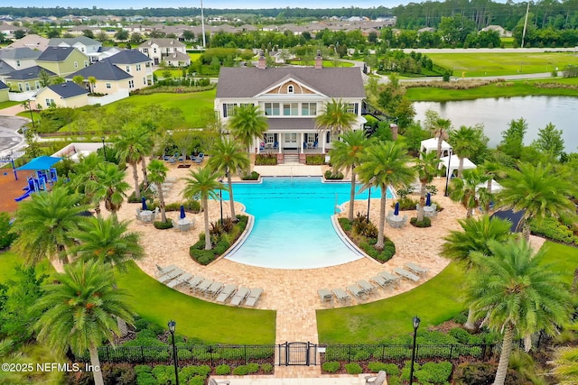 view of pool featuring a patio area and a water view