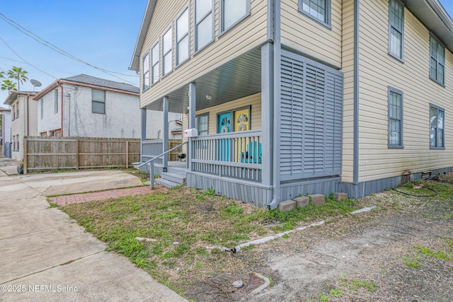 view of side of home with covered porch