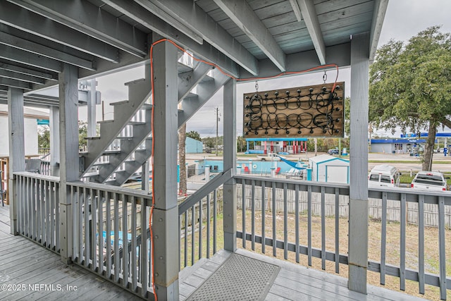 wooden deck featuring a community pool