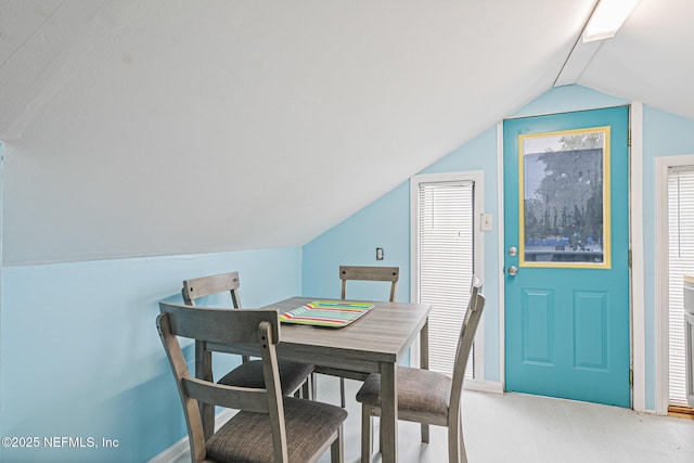 dining room with vaulted ceiling