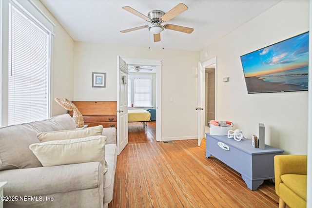 living room featuring ceiling fan and hardwood / wood-style flooring