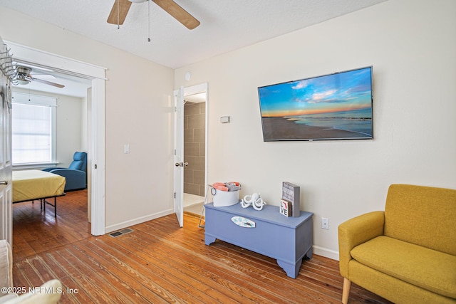 sitting room with a textured ceiling and hardwood / wood-style flooring