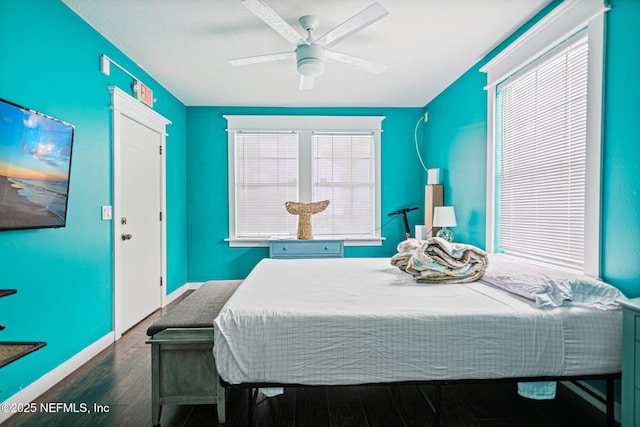 bedroom with ceiling fan and dark hardwood / wood-style flooring