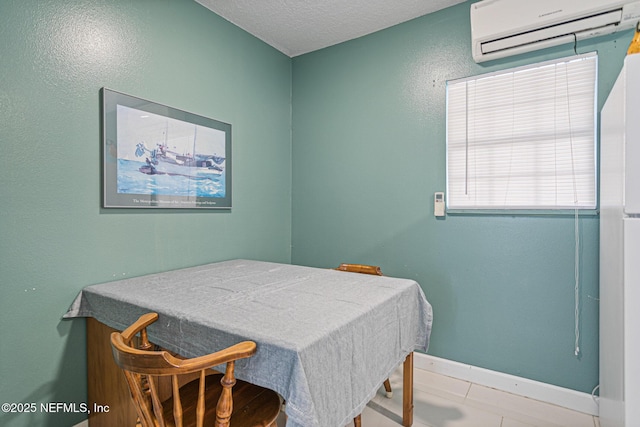 tiled dining area with a textured ceiling and a wall mounted air conditioner