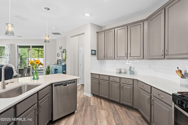 kitchen featuring gray cabinets, dishwasher, hanging light fixtures, light hardwood / wood-style flooring, and sink