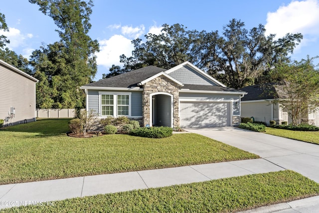 view of front of property with a front yard and a garage