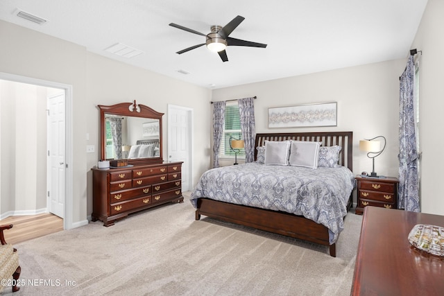 bedroom featuring light carpet and ceiling fan