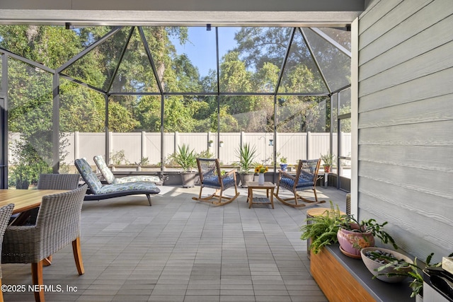 view of patio featuring a lanai