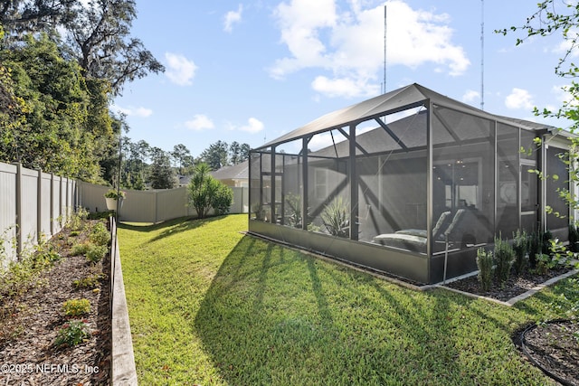 view of yard featuring glass enclosure and a sunroom