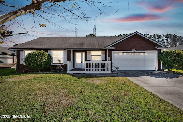 single story home with a garage, a yard, and a porch