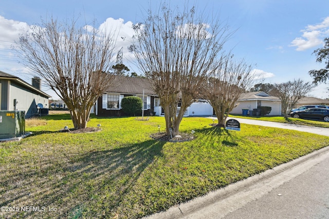 ranch-style house featuring a front lawn and central AC