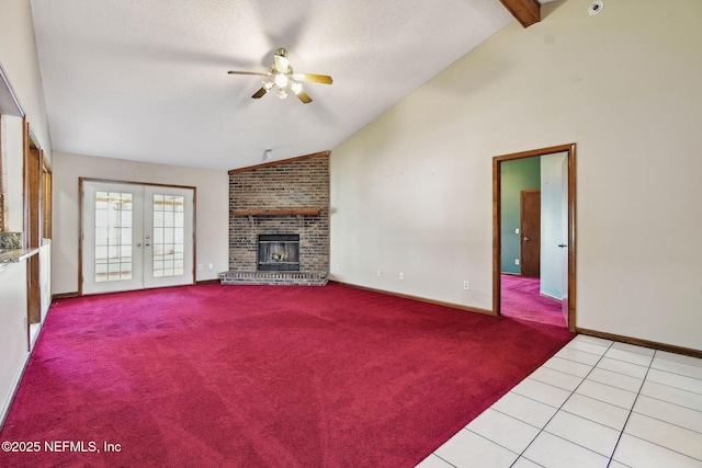 unfurnished living room featuring ceiling fan, light tile patterned floors, lofted ceiling with beams, and french doors