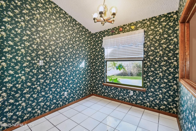 unfurnished room featuring light tile patterned floors, a chandelier, and a textured ceiling