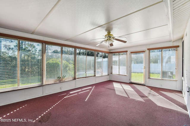 unfurnished sunroom with ceiling fan