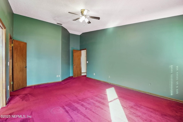 unfurnished bedroom with ceiling fan, a textured ceiling, and carpet