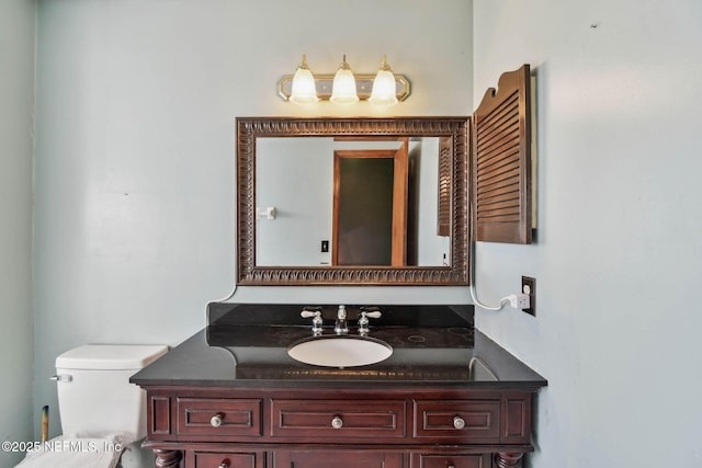 bathroom with toilet and vanity