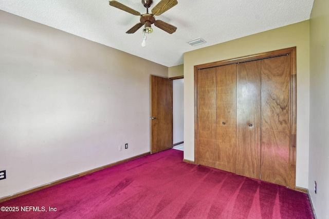 unfurnished bedroom featuring a textured ceiling, ceiling fan, a closet, and carpet floors