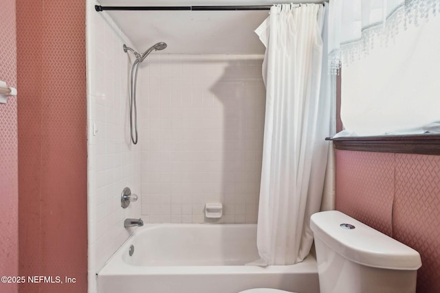 bathroom featuring toilet and shower / bathtub combination with curtain