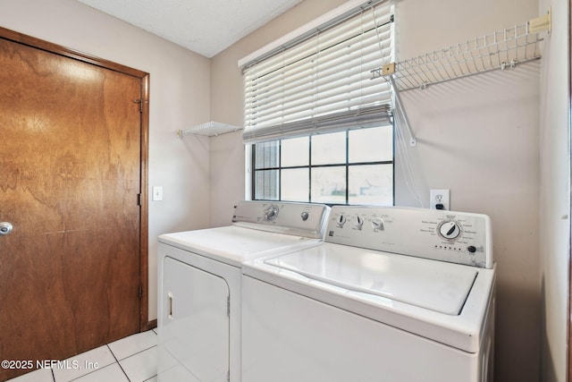 laundry area featuring light tile patterned floors and separate washer and dryer