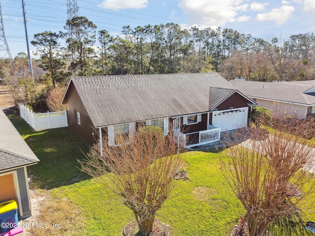 view of front of house with a front yard and a garage