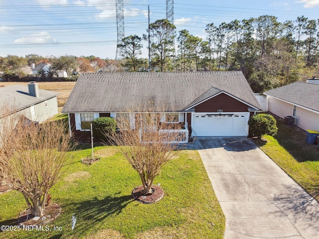 view of front facade featuring a front lawn, central AC unit, and a garage