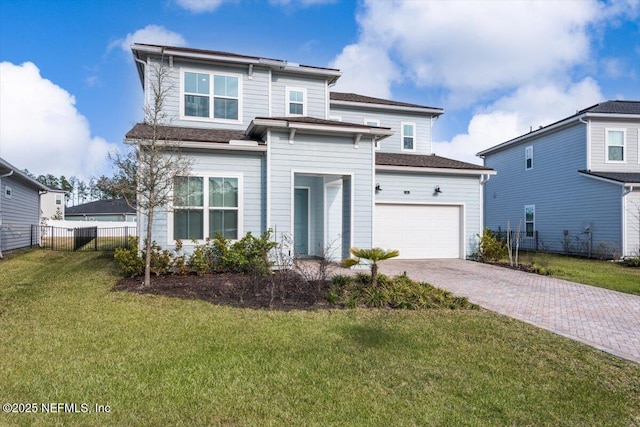 view of front of property featuring an attached garage, fence, decorative driveway, and a front yard