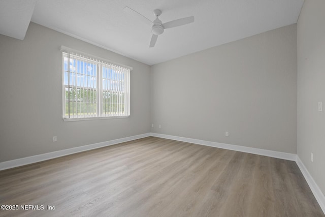 empty room featuring ceiling fan and light hardwood / wood-style floors