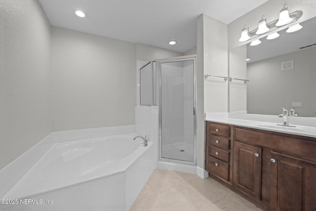 bathroom featuring vanity, independent shower and bath, and tile patterned floors