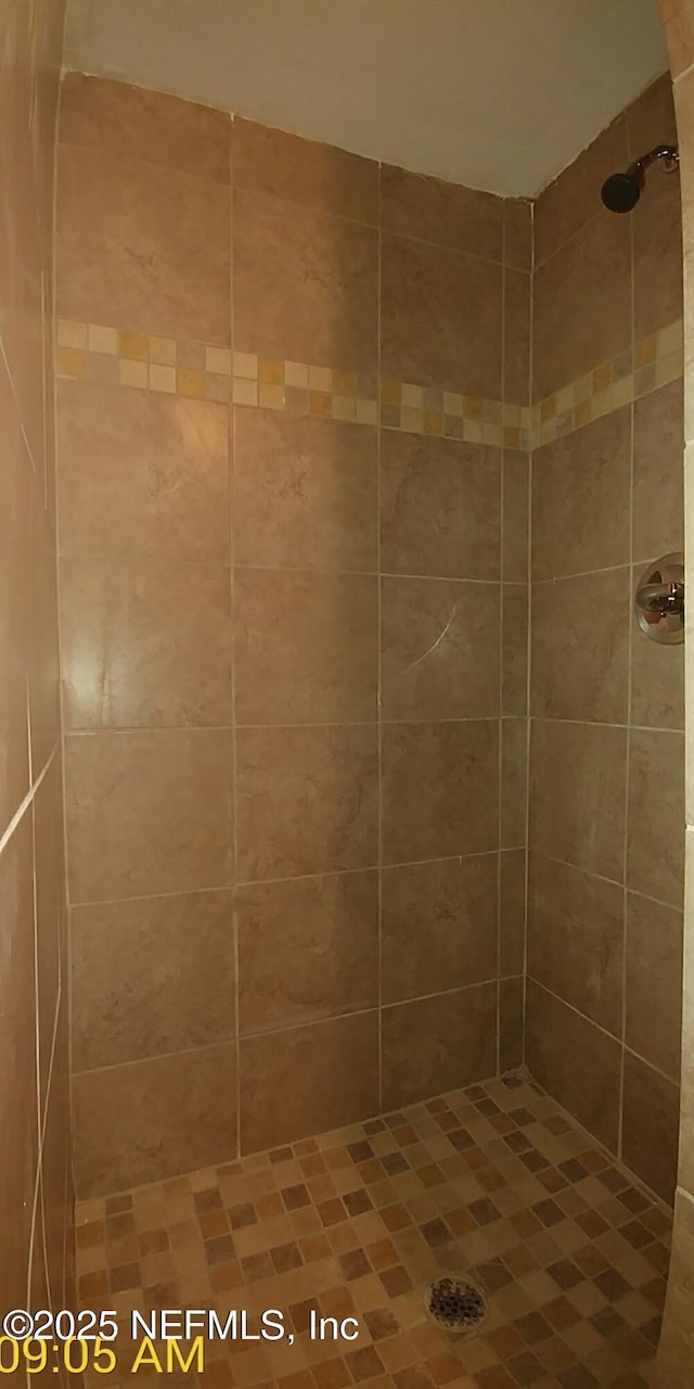 bathroom with a tile shower