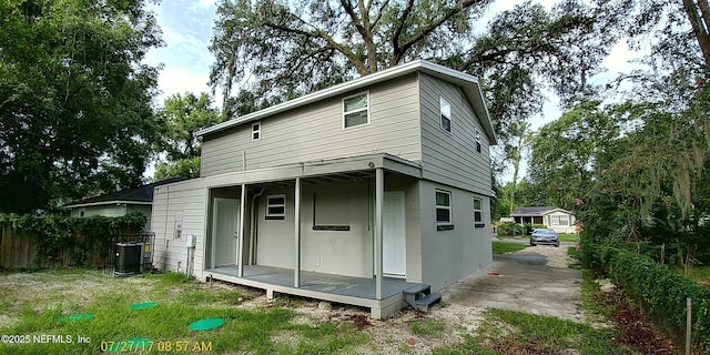 back of house featuring central air condition unit