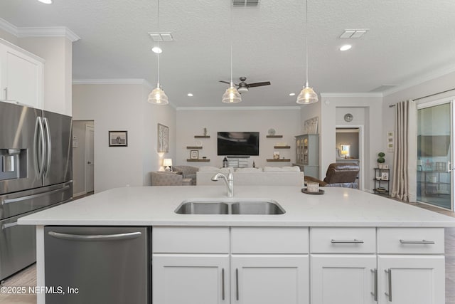 kitchen featuring sink, stainless steel appliances, white cabinetry, and a textured ceiling