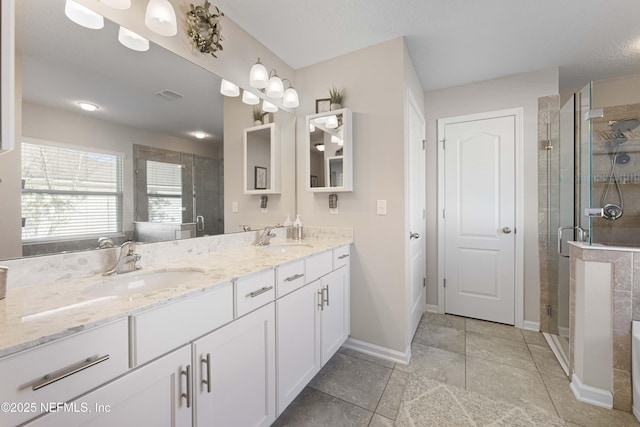 bathroom featuring an enclosed shower and vanity