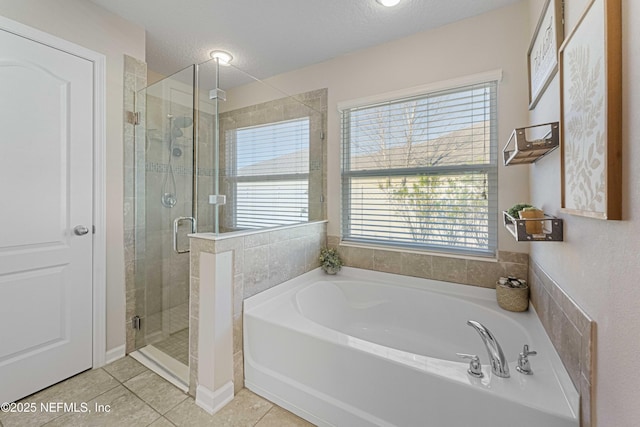 bathroom with independent shower and bath, a textured ceiling, and tile patterned flooring